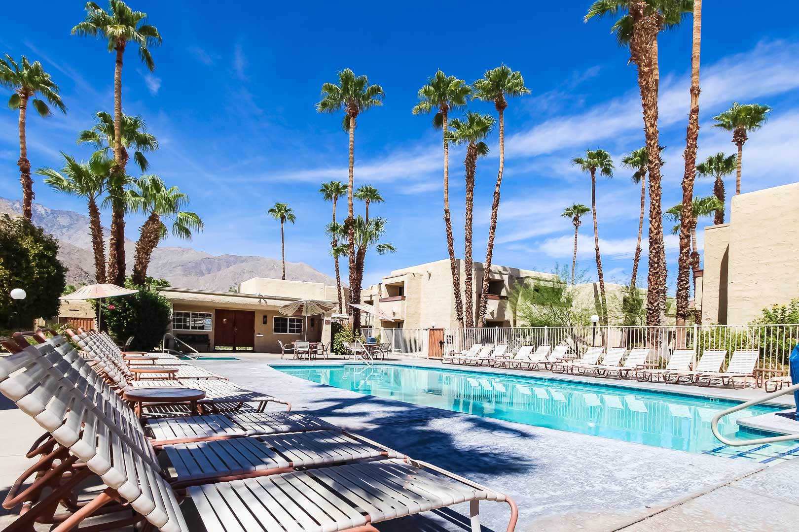 Beautiful skies and an outdoor swimming pool at VRI's Desert Vacation Villas in Palm Springs California.